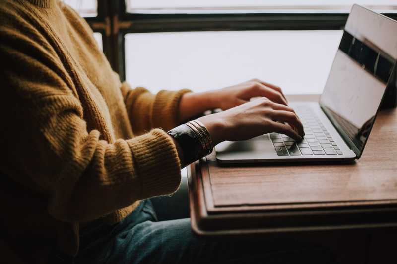 Person sitting front of laptop. By Christin Hume on Unsplash