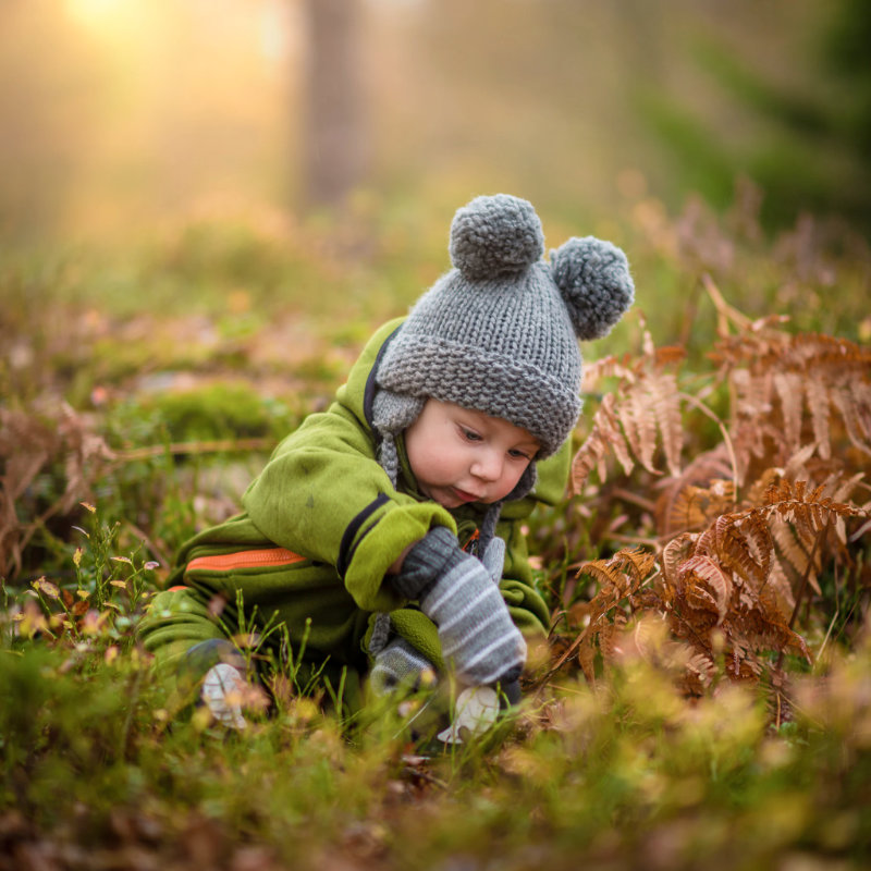 child playing with leaves