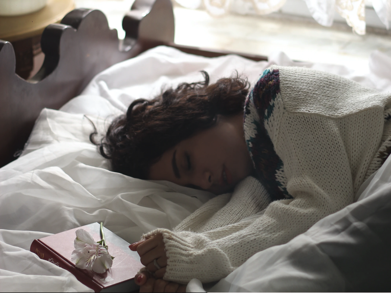 Person sleeping next to their journal